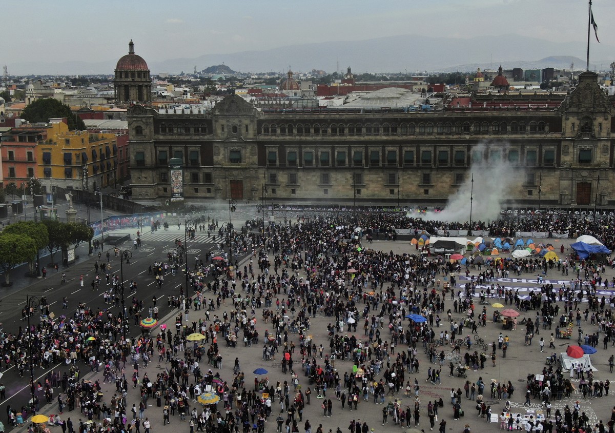 A plume from a fire extinguisher fired by the police to disperse demonstrators rises outside Mexico's Presidential Palace during a march commemorating International Women's Day in Mexico Cit ...