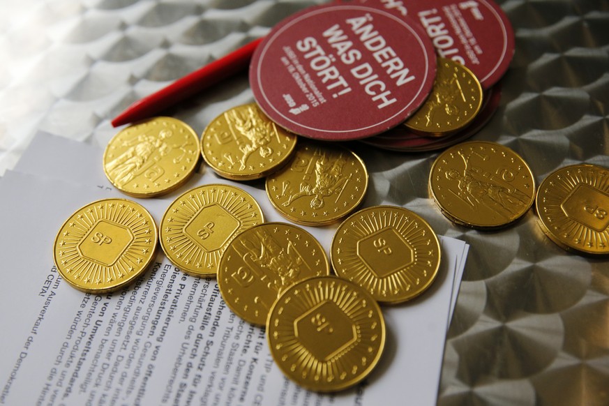 Schokoladengoldmuenzen mit dem Logo der SP liegen auf einem Tisch, am Samstag, 25. April 2015 bei der Delegiertenversammlung der SP Schweiz in Bern. (KEYSTONE/Peter Klaunzer)