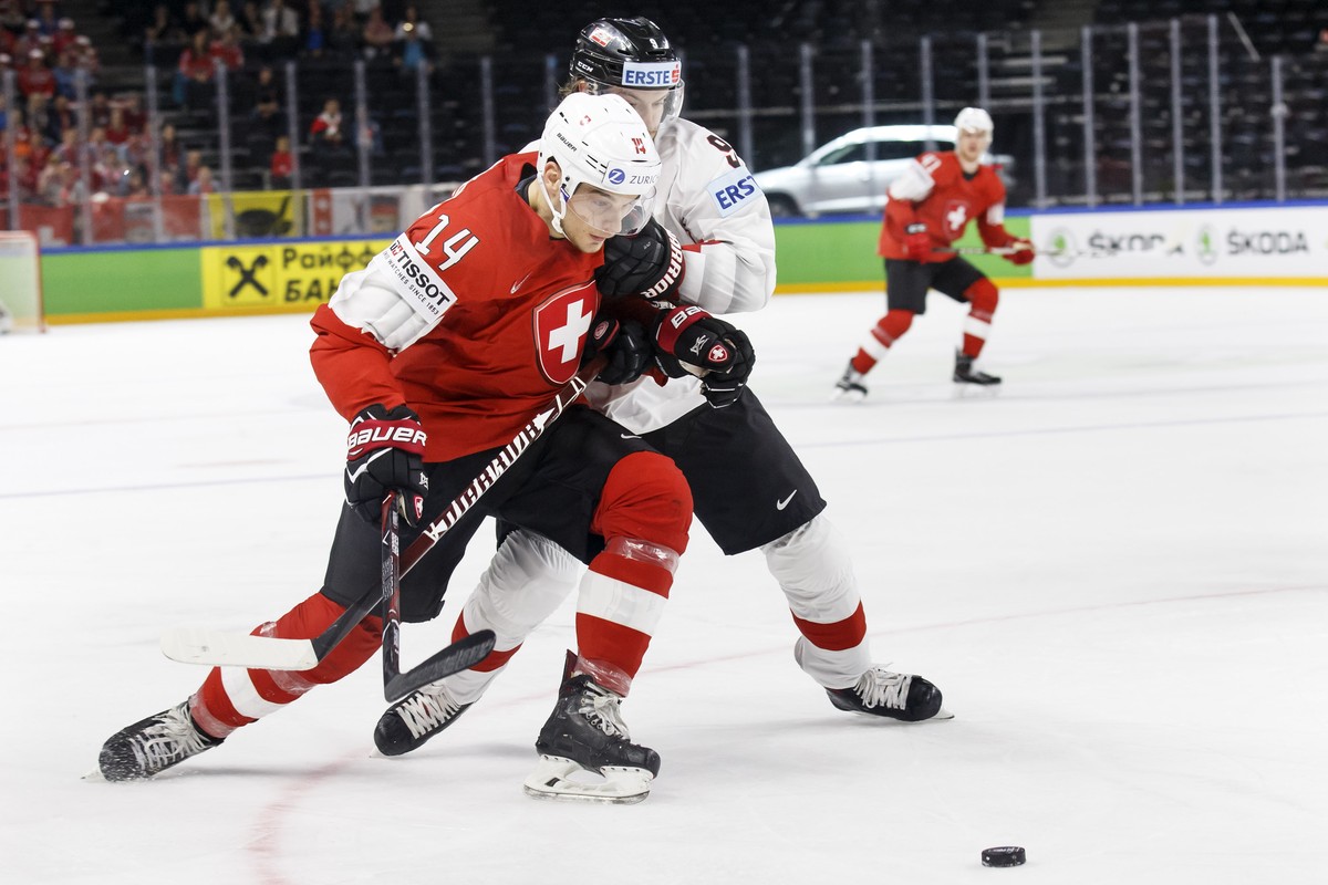 Switzerland's forward Chris Baltisberger, left, vies for the puck with Austria's forward Alexander Rauchenwald, right, during the IIHF 2018 World Championship preliminary round game between  ...