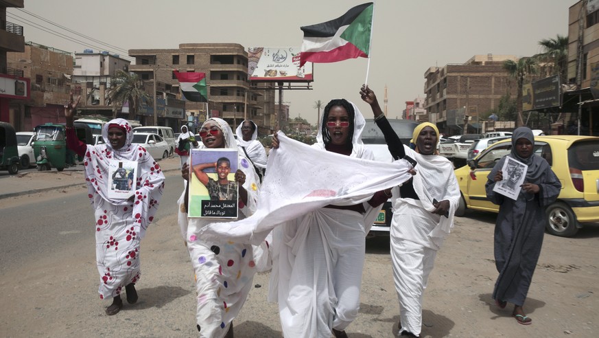Sudanese women chant slogans protesting security forces
