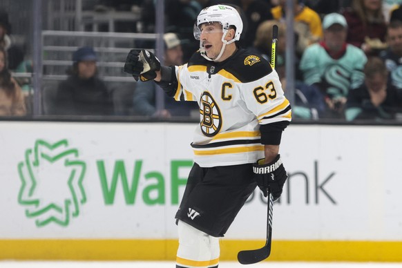 Boston Bruins left wing Brad Marchand (63) celebrates after scoring a penalty shot against Seattle Kraken goaltender Philipp Grubauer during the second period of an NHL hockey game Thursday, Dec. 12,  ...