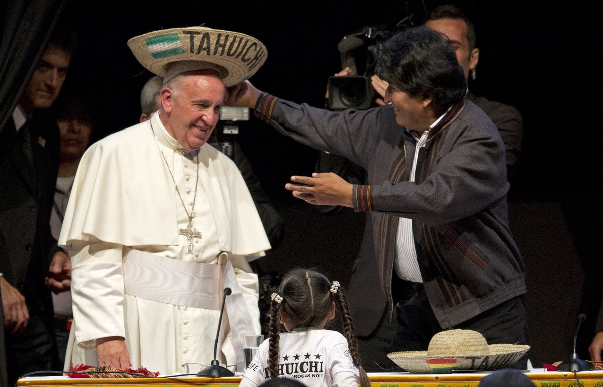 Bolivia's President Evo Morales places a traditional Bolivian hat on Pope Francis' head during the second World Meeting of Popular Movements in Santa Cruz, Bolivia, Thursday, July 9, 2015. T ...