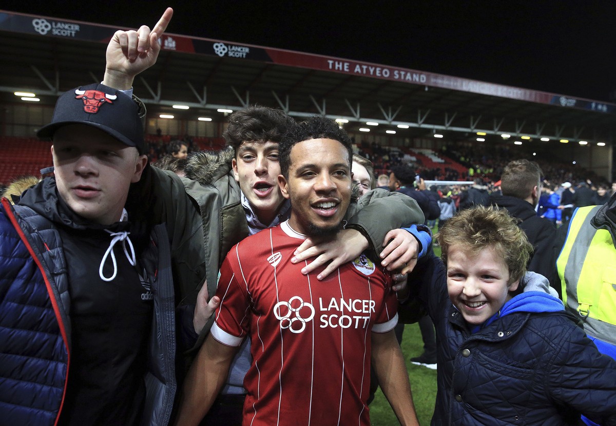 Bristol City's Korey Smith celebrates scoring his side's second goal of the game with fans after the final whistle in the English League Cup Quarter Final soccer match between Bristol City a ...