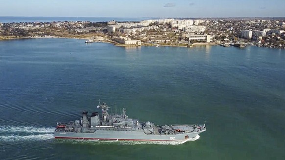 In this reaching photo released by the Russian Ministry of Defense press service on Thursday, February 10, 2022, the Russian Navy's Kaliningrad amphibious assault ship sails into the port of Sevastopol in Cri...