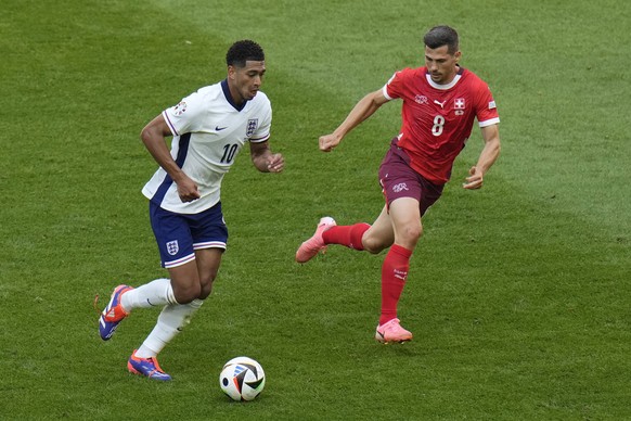 England&#039;s Jude Bellingham controls the ball while Switzerland&#039;s Remo Freuler defends during a quarterfinal match between England and Switzerland at the Euro 2024 soccer tournament in Duessel ...