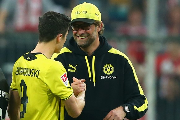 MUNICH, GERMANY - APRIL 12: Juergen Klopp, head coach of Dortmund celebrates victory with his player Robert Lewandowski after winning the Bundesliga match between FC Bayern Muenchen and BVB Borussia D ...