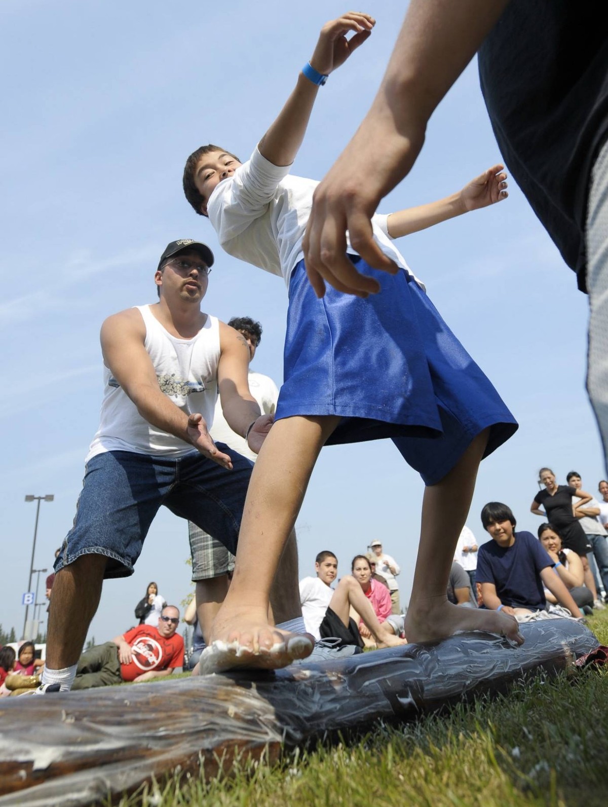 090719) -- FAIRBANDS, July 19, 2009 -- A young man balances himself on a greased pole during the Greased Pole Walk contest in the 2009 World Eskimo-Indian Olympics held in Fairbanks, Alaska of the Uni ...