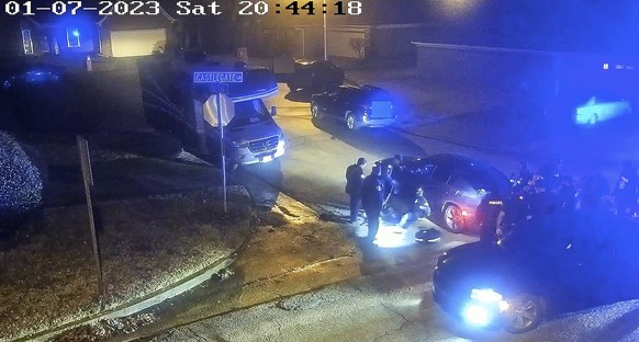 FILE - In this image from video released by the City of Memphis, paramedics stand near Tyre Nichols, seated leaning against a car, as police officers, right, stand at the scene following a brutal atta ...
