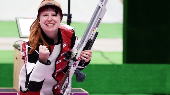 epa09360668 Third placed Nina Christen of Switzerland celebrates at the end of the 10m Air Rifle Women&#039;s Final of the Shooting events of the Tokyo 2020 Olympic Games at the Camp Asaka in Nerima,  ...