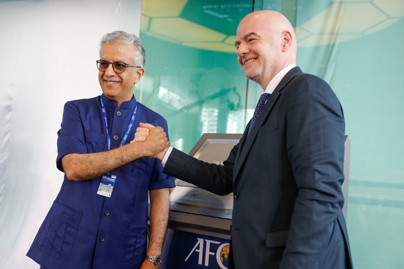 FILE - Asia Football Confederation President Salman Bin Ibrahim Al-Khalifa, left, poses with FIFA President Gianni Infantino during an inauguration ceremony for the new building of the Asia Football C ...