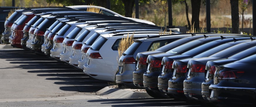 In this Thursday, Sept. 24, 2015, photo, Volkswagen cars for sale are on display on the lot of a dealership in Boulder, Colo. General Motors and Ford each posted strong U.S. sales in September 2017, c ...