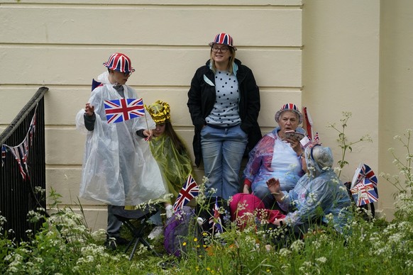 Royal fans wearing Union Jack colors wait to witness the procession of the coronation of Britain&#039;s King Charles III in London Saturday, May 6, 2023. (AP Photo/Alberto Pezzali)