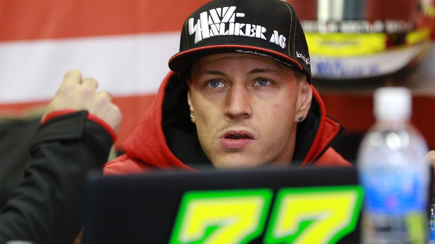 Moto2 rider Dominique Aegerter of Switzerland looks at a monitor during the free practice session for the MotoGP Japanese Motorcycle Grand Prix at the Twin Ring Motegi circuit in Motegi, north of Toky ...