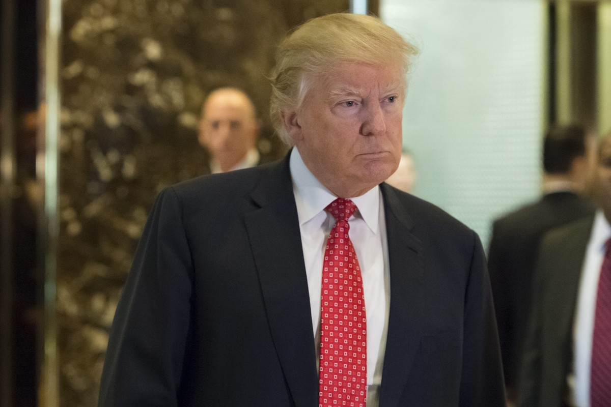 epa05708065 US President-elect Donald Trump speaks with journalists in the lobby of Trump Tower, after meeting with LVHM Fashion's Alexandre and Bernard Arnault, New York, New York, USA, 09 Janua ...