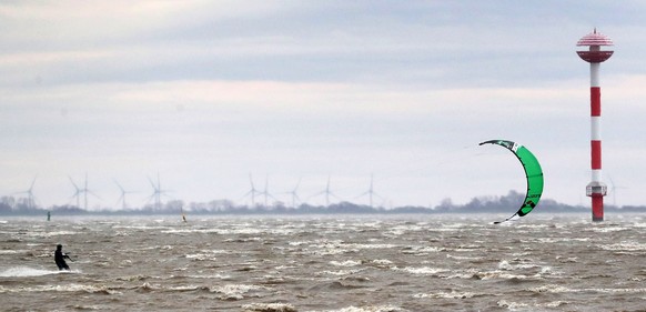 epa08205646 A kite surfer on the Weser river while storm Sabine hits Bremerhaven, northern Germany, 09 February 2020. According to the German Weather Service (DWD), storm Sabine will spread to the nor ...