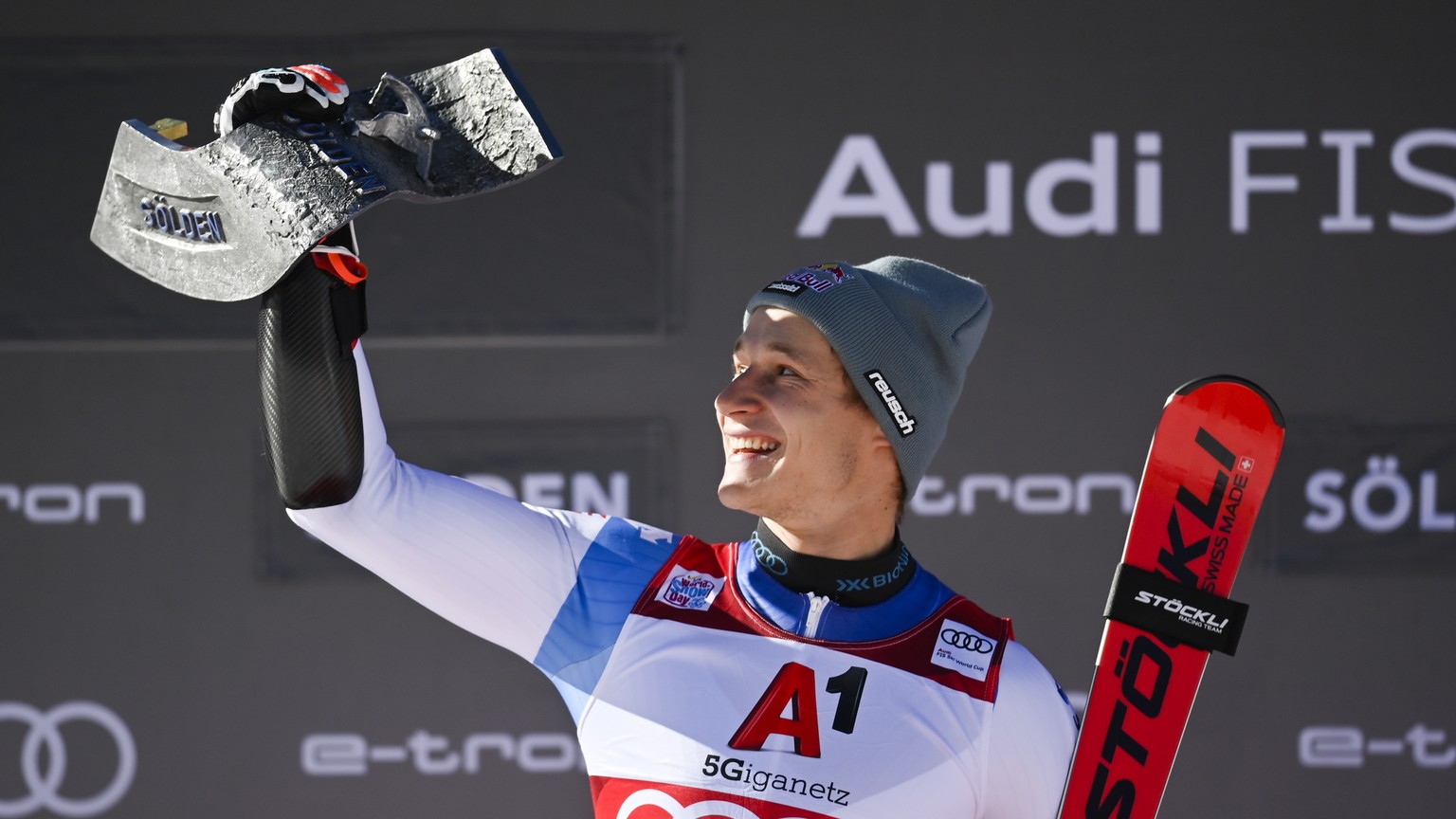 epa09543283 Marco Odermatt of Switzerland celebrates with his trophy on the podium after winning the men&#039;s Giant Slalom at the FIS Alpine Skiing World Cup season opener on the Rettenbach glacier  ...