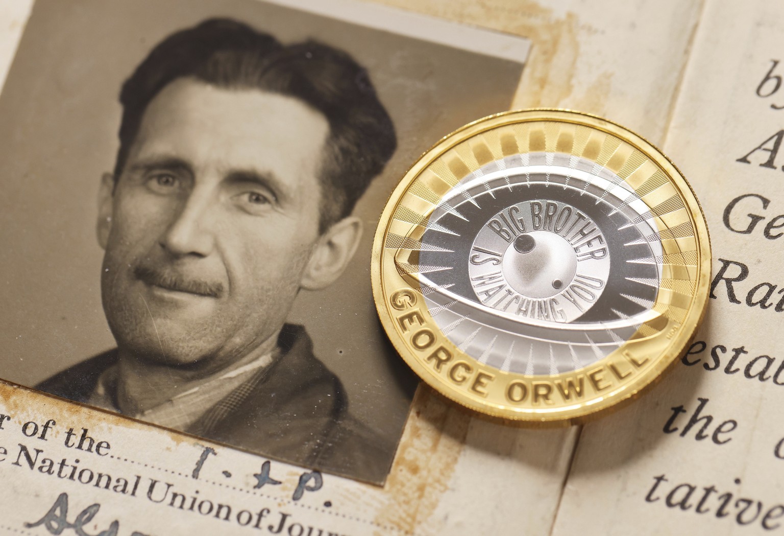 This photo, provided by The Royal Mint on Monday, Jan. 13, 2025, shows a portrait of George Orwell and a new �2 coin. (The Royal Mint/PinPep via AP)