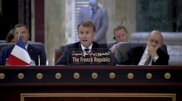 A photo released by the Iraqi Prime Minister Media Office shows French President Emmanuel Macron attends the Baghdad Conference for Cooperation and Partnership in Baghdad, Saturday, Aug. 28, 2021. (Ir ...