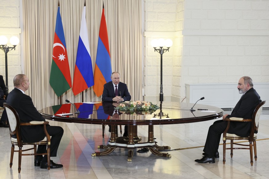 Russian President Vladimir Putin, center, Azerbaijan&#039;s President Ilham Aliyev, left, and Armenian Prime Minister Nikol Pashinyan, right, talk during their meeting in the Bocharov Ruchei residence ...