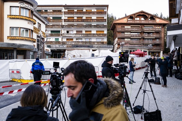 epa12621415 Members of the media work in front of the area where an unidentified origin fire broke out at the 'Le Constellation' bar and lounge leaving people dead and injured, during New Ye ...