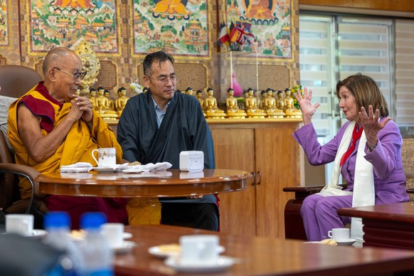 epa11421537 A handout photo made available by the Dalai Lama Media office shows former US House speaker Nancy Pelosi (R) as she gestures during a meeting with Dalai Lama (L) at his residence in Dharam ...