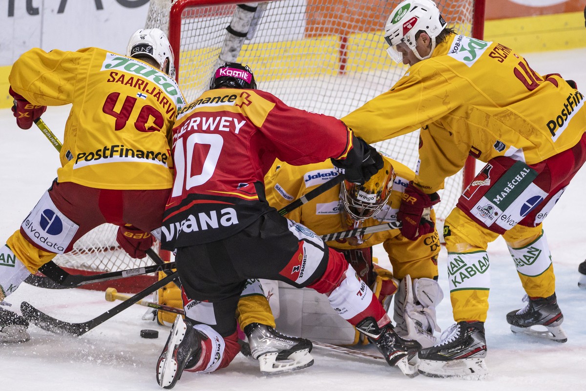 Langnaus Torhueter Luca Boltshauser, 2. von rechts, behaelt die Uebersicht vor den stochernden Langnaus Vili Saarijaervi, Berns Tristan Scherwey und Langnaus Flavio Schmutz, von links, im Eishockey Qu ...