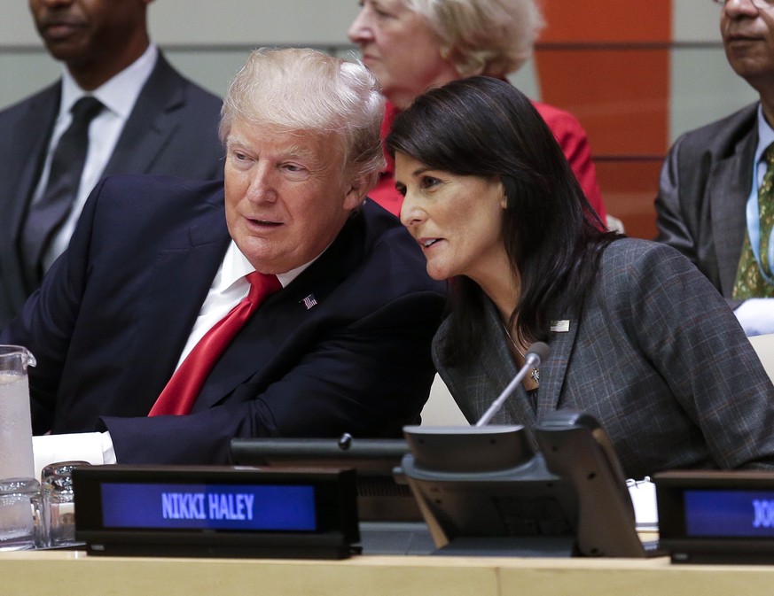 FILE - President Donald Trump speaks with Nikki Haley, U.S. Ambassador to the United Nations, before a meeting during the United Nations General Assembly at UN Headquarters, Sept. 18, 2017. Haley, the…