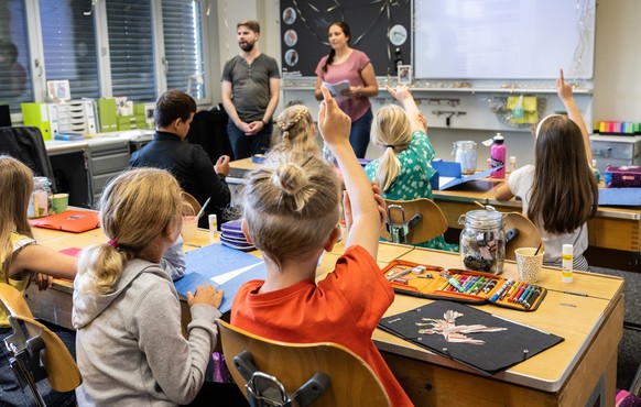 Kinder sitzen in der 1. und 2. Klasse von Lehrer Micha Kohler und Studentin Lisa Siegenthaler, am Montag, 15. August 2022, an der Primarschule in Lauperswil im Emmental. Wie in der ganzen Schweiz herr ...