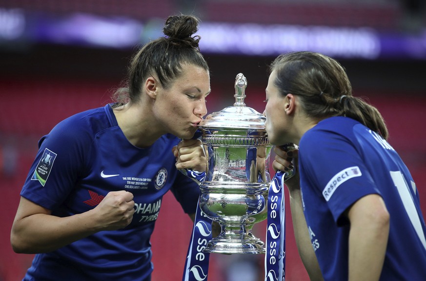 Chelsea Ladies&#039; Ramona Bachmann, left, and Fran Kirby kiss the trophy after winning against Arsenal Women, during the Women&#039;s FA Cup Final at Wembley Stadium in London, Saturday May 5, 2018. ...