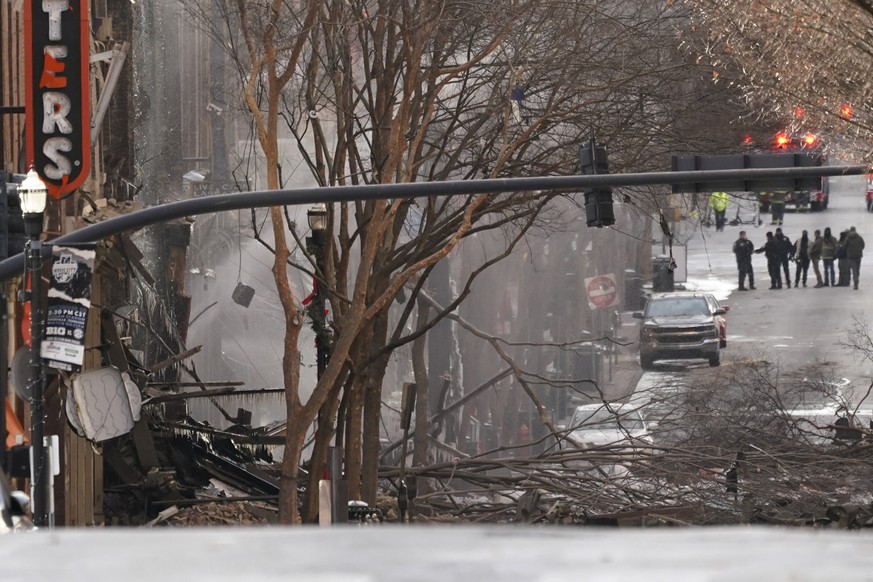 Emergency personnel work at the scene of an explosion in downtown Nashville, Tenn., Friday, Dec. 25, 2020. Buildings shook in the immediate area and beyond after a loud boom was heard early Christmas  ...