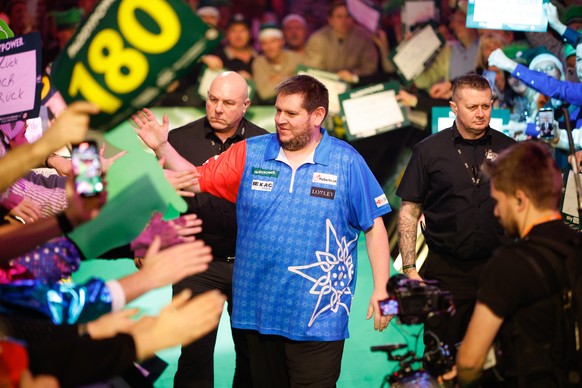 epa11779788 Stefan Bellmont of Switzerland enters during the opening session of the Paddy Power World Darts Championship at Alexandra Palace in London, Britain 15 December 2024. EPA/DAVID CLIFF