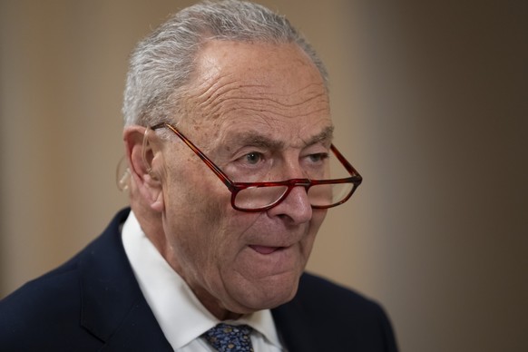 Senate Minority Leader Chuck Schumer, D-N.Y., gives a television interview, as the Senate works to avert a partial government shutdown ahead of the midnight deadline, at the Capitol in Washington, Fri ...
