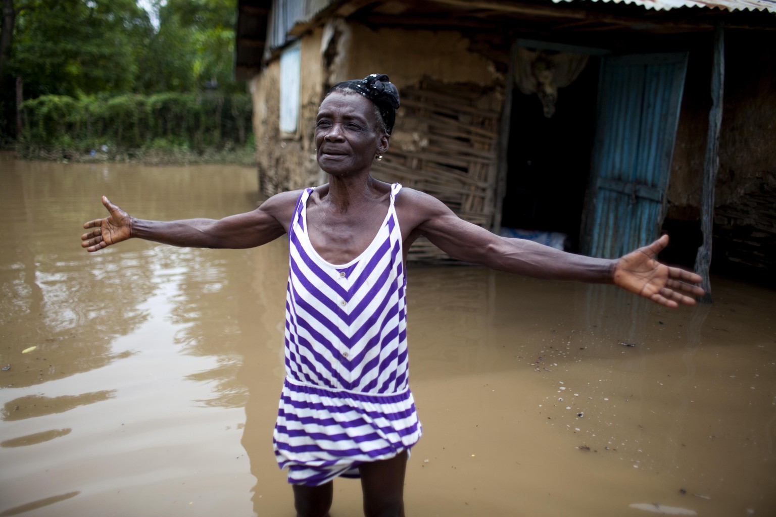 Lucita Leonce 71, complains in front of her home flooded by heavy rains brought on by Hurricane Irma, in Fort-Liberte, Haiti, Friday Sept. 8, 2017. Irma rolled past the Dominican Republic and Haiti an ...