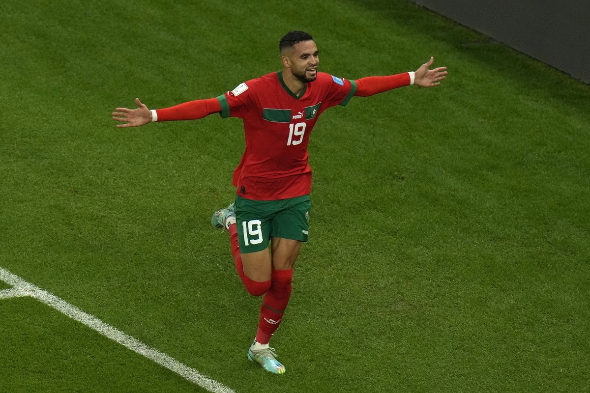 Morocco's Youssef En-Nesyri celebrates after scoring his side's opening goal during the World Cup quarterfinal soccer match between Morocco and Portugal, at Al Thumama Stadium in Doha, Qatar ...
