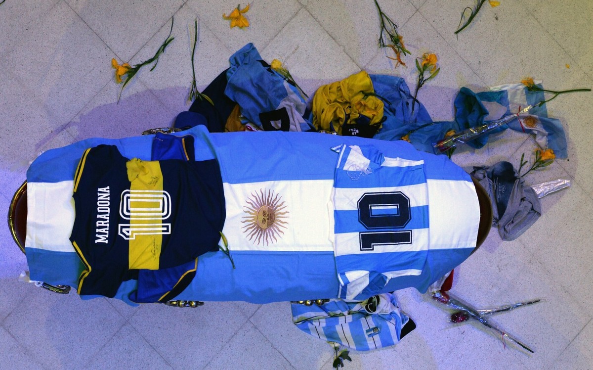 In this photo released by Argentina's Presidency the coffin with the remains of Diego Maradona lies in state inside the presidential palace in Buenos Aires, Argentina, Thursday, Nov. 26, 2020. Th ...