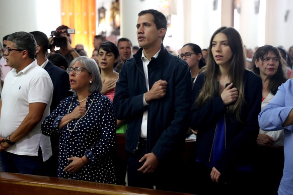 epa07325895 The President of the National Assembly (Parliament) of Venezuela and self-proclaimed interim President of the country Juan Guaido (C), attends a mass in the company of his mother Norka Már ...