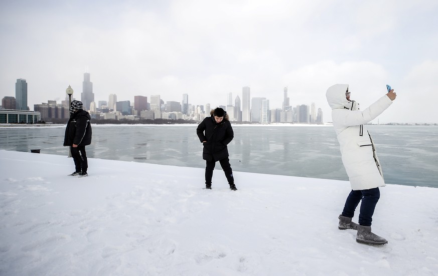 epa07330186 A High School student from China takes a selfie along Lake Michigan in Chicago, Illinois, USA, 29 January 2019. The US Midwest is braced with a coldspell as a polar vortex sent temperature ...