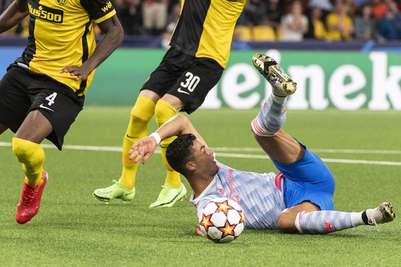 Manchester's Cristiano Ronaldo falls after a clash with YB players, during the UEFA Champions League group F soccer match between BSC Young Boys and Manchester United, on Tuesday, September 14, 2021 a ...