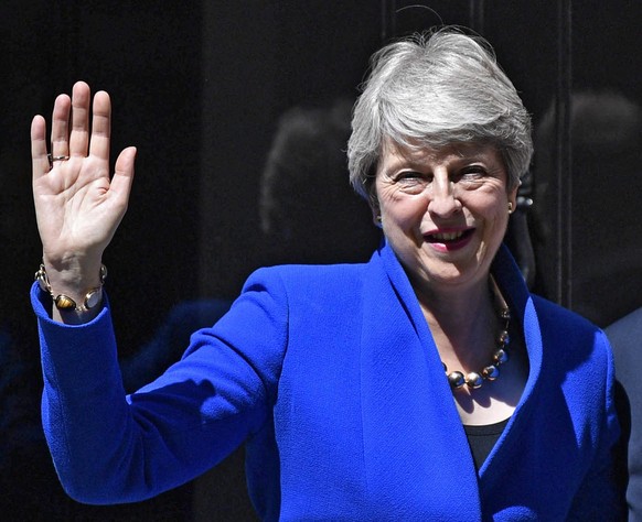 epa07737339 British Prime Minister Theresa May waves as she leaves 10 Downing Street before departing to Buckingham Palace in London, Britain, 24 July 2019. Theresa May is stepping down as British Pri ...
