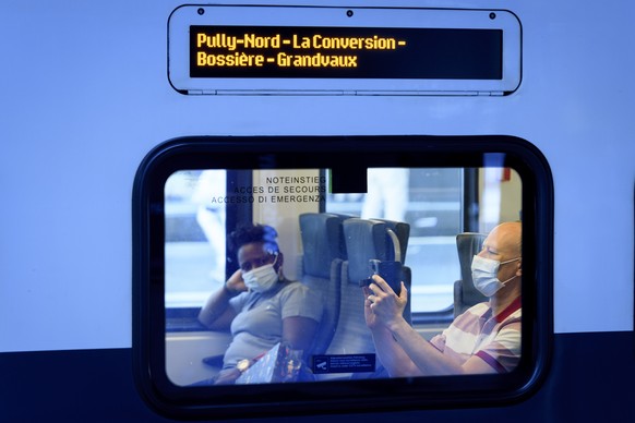 People wearing protective mask ride a SBB CFF train during the coronavirus disease (COVID-19) outbreak, at the CFF Lausanne train station, Switzerland, Monday, July 6, 2020. In Switzerland, from Monda ...