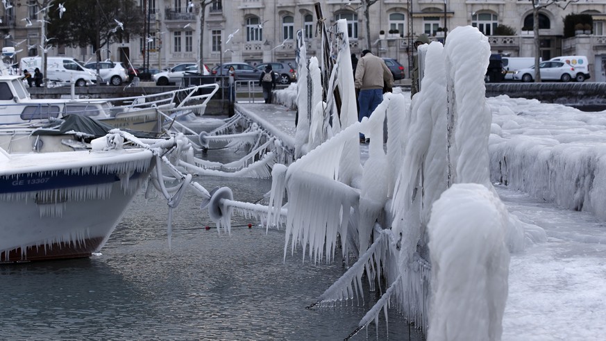 A boat is covered with ice after few days of strong gusts of wind blowing waves of water over the bank of the lake of Geneva, in Geneva, Switzerland, Tuesday, February 27, 2018. Media reports state th ...