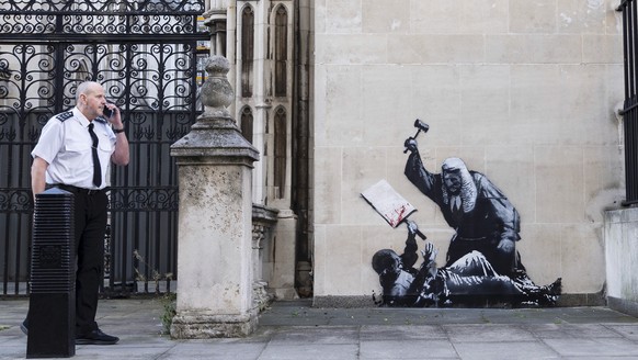 Undated photo released by Banksy of the new artwork by the artist which portrays a judge beating a protester with a gavel at the Royal Courts of Justice in London. (Banksy via AP)
Britain Banksy