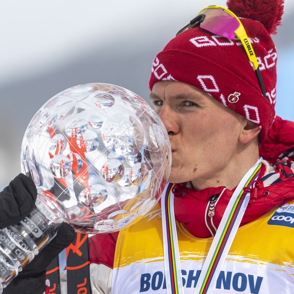 epa09073522 First placed of the Overall FIS Cross Country World Cup Alexander Bolshunov of Russia poses in S-Chanf, Switzerland, 14 March 2021. EPA/GIAN EHRENZELLER