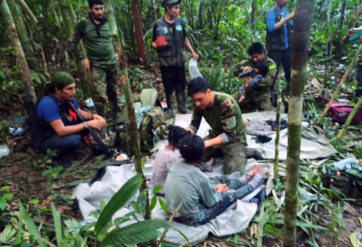 epa10682580 A handout photo made available by the Military Forces of Colombia shows soldiers and indigenous people as they attend to the children rescued after 40 days in the jungle, in Guaviare, Colo ...