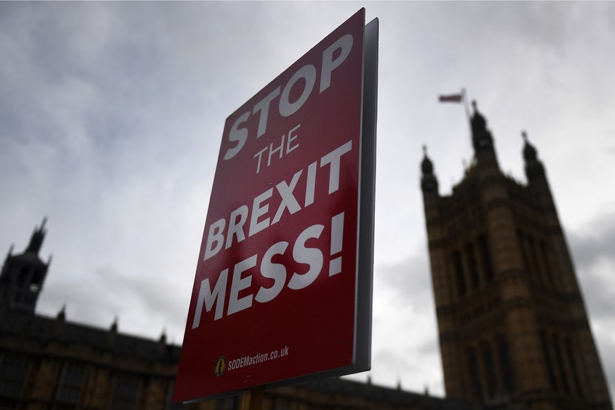 epa07197295 Pro EU protesters hold a placard that reads &#039;Stop the Brexit Mess&#039; outside Parliament in London Britain, 29 November 2018. Members of Parliament (MP&#039;s) are set to vote on Br ...