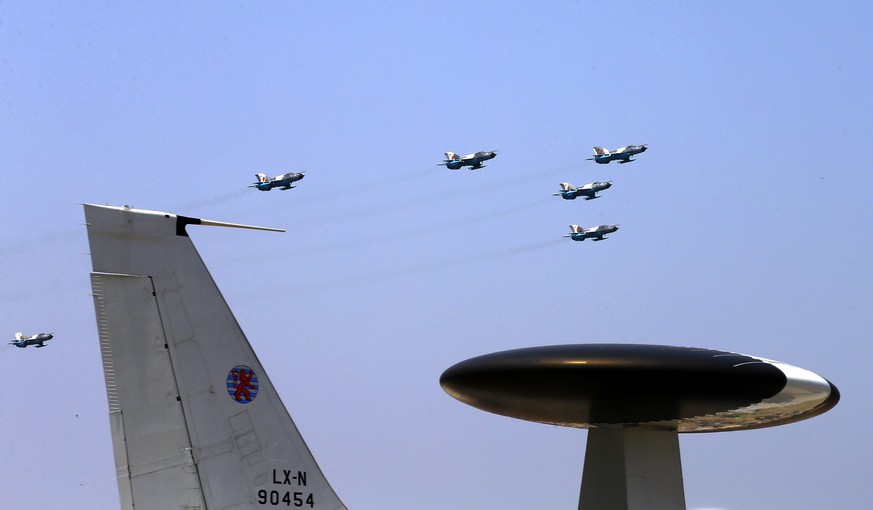 epa05448880 Romanian military pilots fly their Russian made MIG 21 Lancer jets over a NATO AWACS tactical airplane (foreground) at the Bucharest International Air Show 2016 (BIAS), held at Baneasa air ...