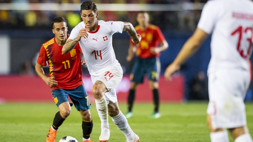 Spain&#039;s midfielder Lucas Vazquez, left, fights for the ball with Switzerland&#039;s midfielder Steven Zuber, center, during an international friendly soccer match in preparation for the upcoming  ...