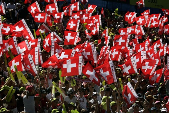 Swiss fans support their team during the pool round match between Brazils&#039; Renata Ribeiro and Talita Antunes against Switzerland&#039;s Simone Kuhn and Lea Schwer at the FIVB Beachvolleyball Worl ...