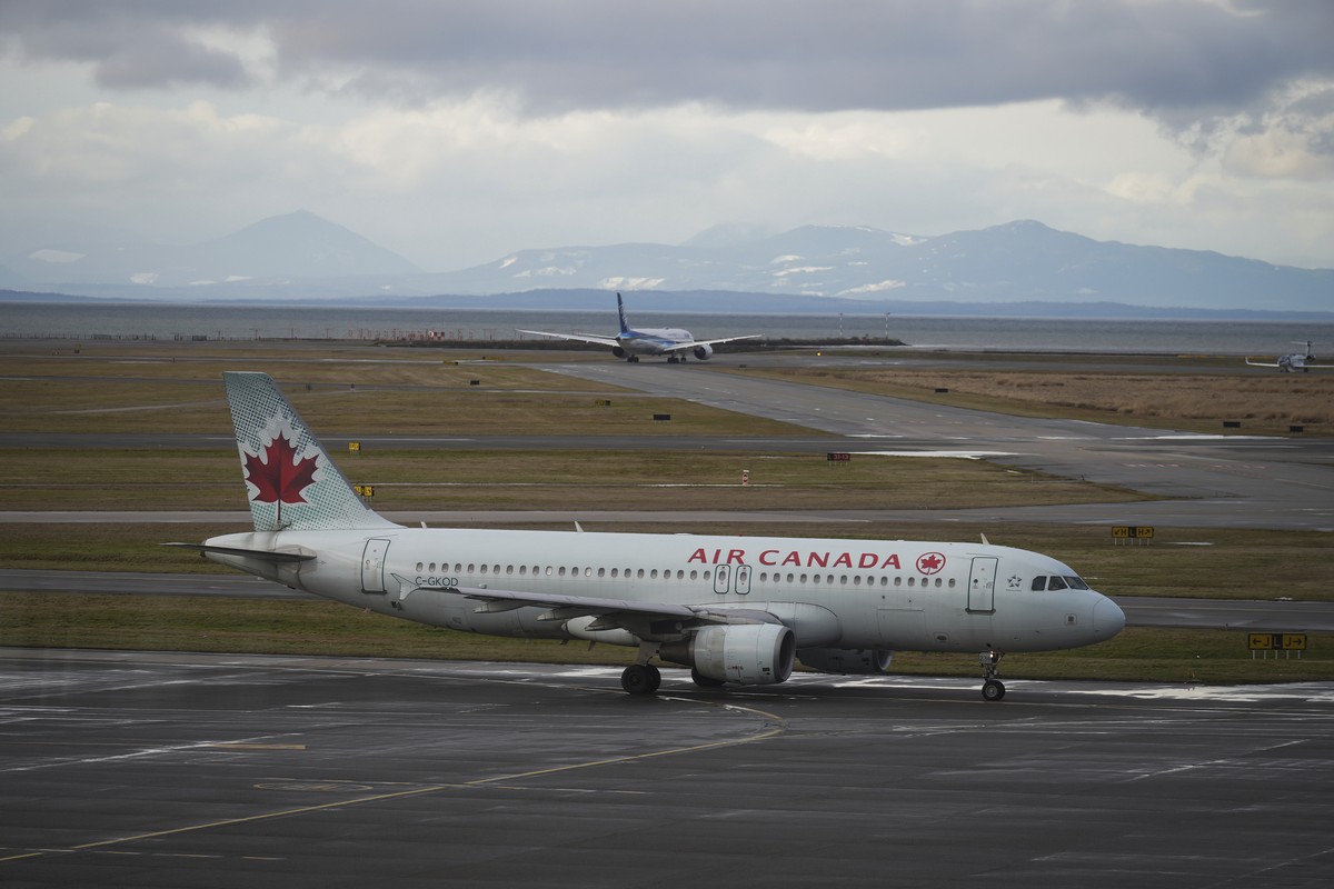 An Air Canada aircraft taxis at Vancouver International Airport after operations returned to normal after last week's snowstorm, in Richmond, British Columbia, on Monday, Dec. 26, 2022. (Darryl D ...