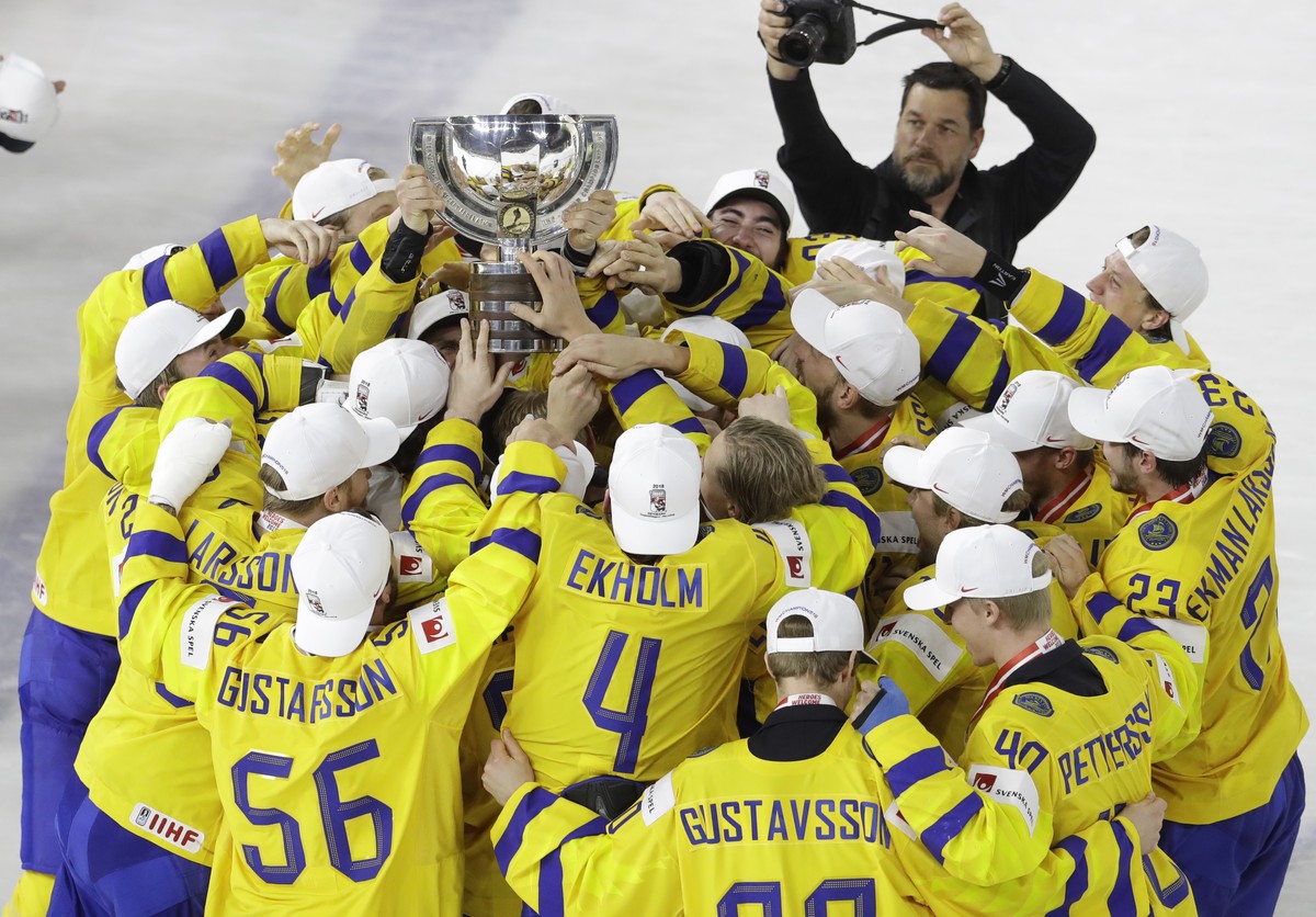 Sweden's players celebrate with the trophy their victory over Switzerland in the Ice Hockey World Championships final match between Sweden and Switzerland at the Royal arena in Copenhagen, Denmar ...